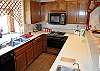 Full, bright kitchen with all appliances and amenities for home cooked meals.