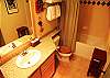 Second bathroom, granite counters and tile shower.