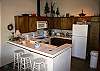 Full kitchen, dishwasher, open floorplan, bar area.