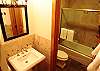 Custom tile flooring and walls, shower/tub combo, upgraded fixtures throughout.