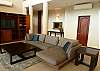 Living area with a large cozy sofa to relax in front of the flat screen TV.
