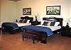 The Three Guest bedrooms are equipped with 2 Queen sized beds per room, offering a perfect repose for company and outfitted with soothing cool colors.