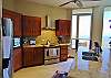 Stainless steel appliances and fully stocked with kitchenware.