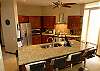 The kitchen has a bar for breakfast or casual dining.