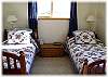 Two twin beds are in one of the bedrooms