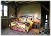 Master bedroom with king size bed and patio doors out to the hot tub