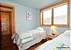 Twin beds in one of the lower level bedrooms