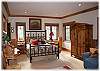 Lower level guest suite with queen bed, a set of bunk beds and a private bath with sauna