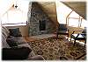The loft area above the great room has some cozy reading space and a second fireplace