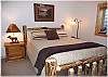 Lower level bedroom with a queen size bed