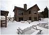 A view of the back of the home in the winter time