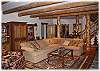 The lower level family room with fireplace, TV, piano and a door out to the hot tub
