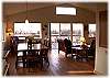 The dining and living areas are bright and sunny with views of the river
