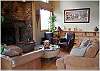 Comfy sofas surround the fireplace