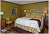 The master bedroom on the upper level with king size bed and attached bath