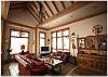A view of the living area.  From the large windows you can see a pond just below the house.