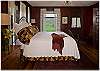 The first floor bedroom in the home with a luxurious king size bed and attached bath
