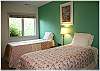 Another lower level bedroom with two twin beds and shared bath