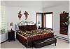 Master bedroom with is own bathroom and door out to the deck and hot tub