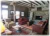 Cozy living room situated around a gorgeous rock fireplace