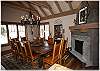 Another view of the cozy dining area with rock fireplace