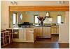 Another view of the dining area and kitchen