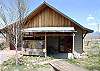 Guest Cottage with with a queen size bed, efficiency kitchen and a small sitting area