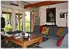 The living area opens to the sunny front porch.