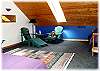 A seating area at the end of the loft bedroom