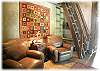 A separate lounge area with two easy chairs has a second flat screen television