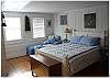 A spacious master bedroom with queen size bed and private bath