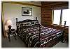 The other main level bedroom with a queen size bed