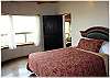 Main floor bedroom with a queen size bed and private bath