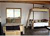 Upstairs bedroom with queen size bed, bunk bed and a chair that makes into a single sofa bed. Also has a deck with an outdoor fireplace.