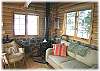 The living room in the guest cabin with a woodstove
