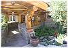 A stone bridge over a creek leads to the front door