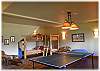 Bunkbeds located in the lower level family room with a ping pong table