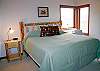 Another upstairs bedroom with a king size bed and its own bathroom