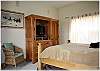 Another look at the master bedroom with a flatscreen TV