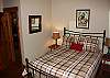 A queen size bedroom in the lower level of the home