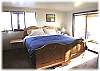 The master bedroom with king size bed on the lower level