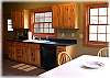 A complete kitchen with a dining table that seats six off to the side