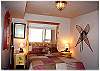 A lower level bedroom with a queen bed