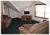An upstairs family room set up to watch television or videos