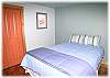 Queen size bed in the other lower level bedroom