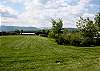 The beautiful lawn separating the barn and cabin.