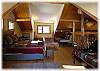 The loft bedroom upstairs with a queen size bed and two single beds
