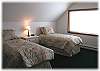 A bedroom set up with two twin beds
