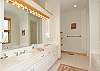 The master bath with a walk-in shower and seperate tub