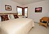 Another upstairs bedroom with a king size bed and its own bathroom